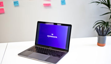 Laptop with violet screen and Cynozure Logo