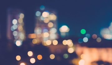 Blurry image of a city with lights on in the night