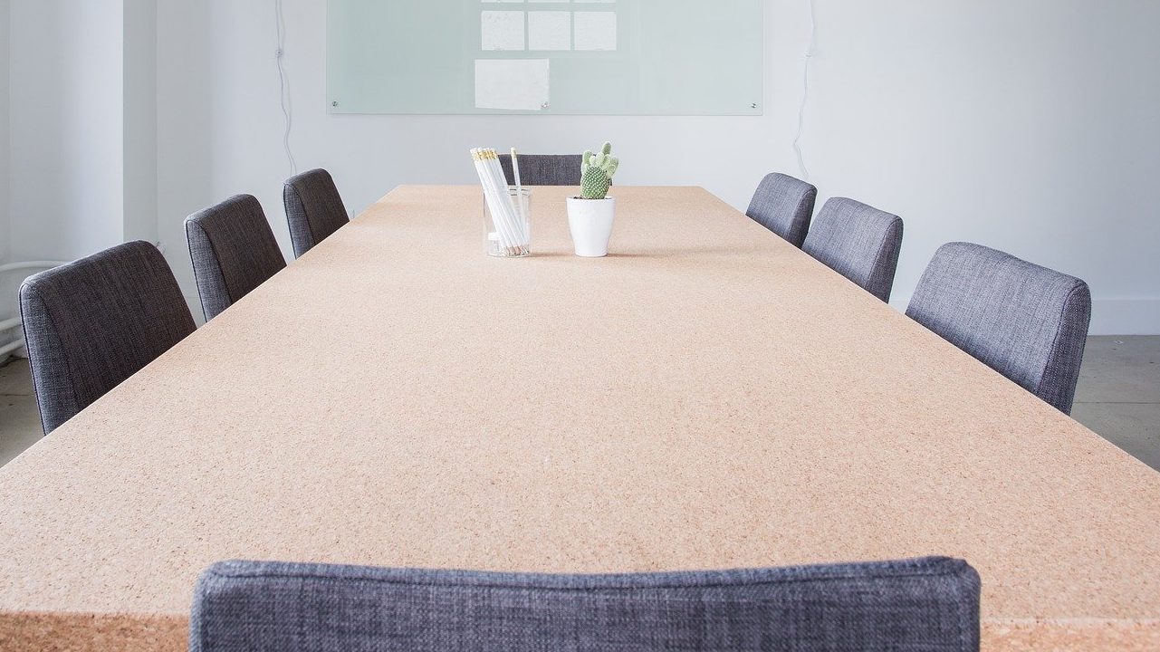 Long tabe with grey chairs aroud