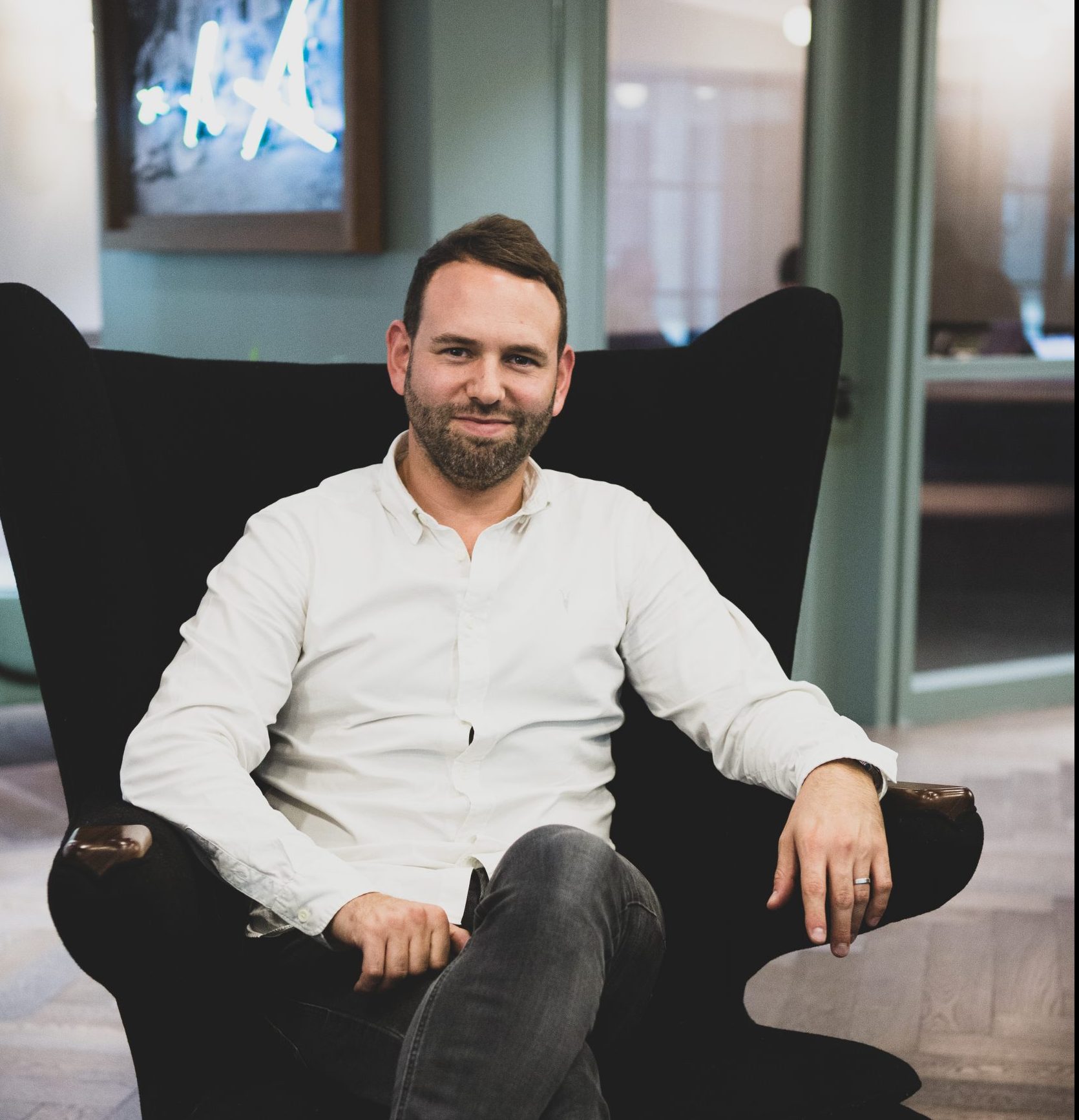 Picture of Jason Foster seating on an armchair