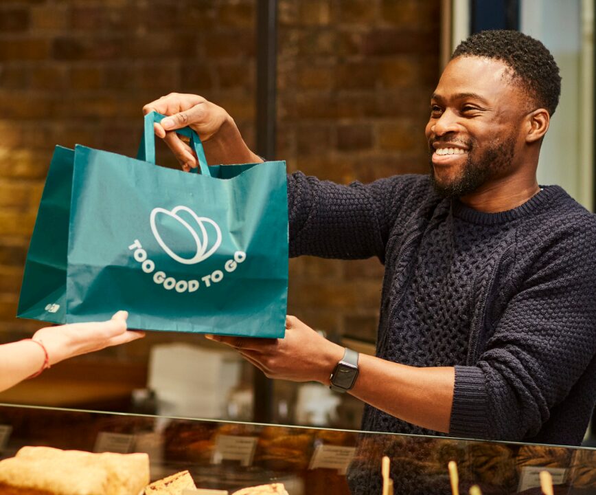 Man handing a bag of food to someone